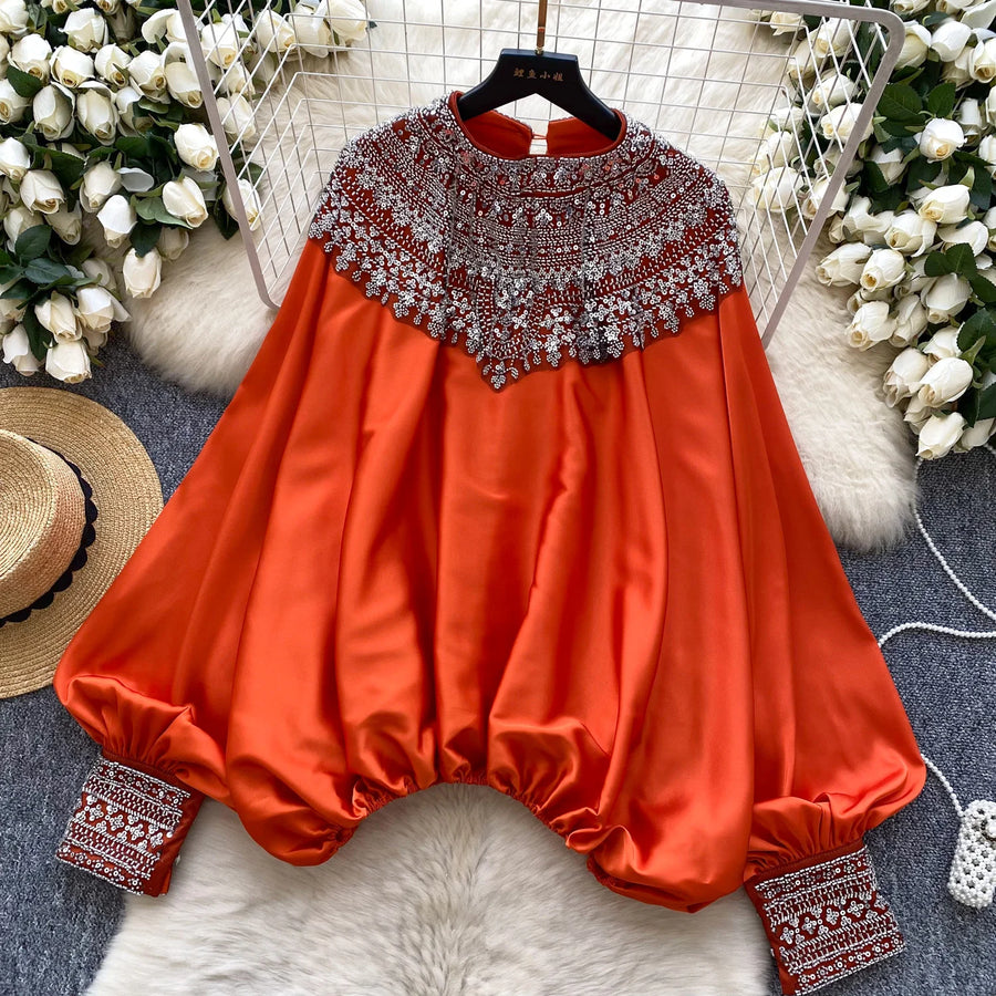 Loose satin blouse with long sleeves and batwing neck, with embroidered beads and high-quality sequins