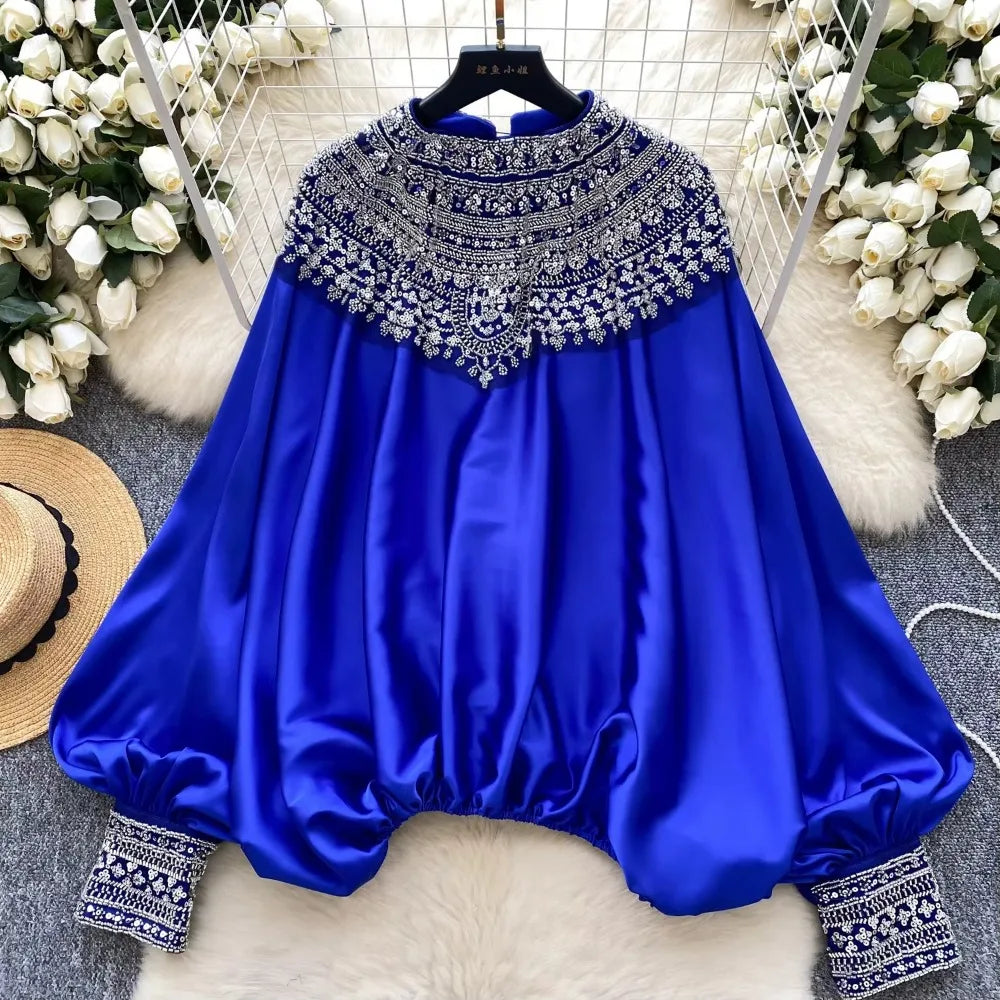 Loose satin blouse with long sleeves and batwing neck, with embroidered beads and high-quality sequins