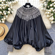 Loose satin blouse with long sleeves and batwing neck, with embroidered beads and high-quality sequins